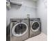 Spacious laundry room with LG washer and dryer and overhead storage at 10230 Old Tampa Bay Dr, San Antonio, FL 33576