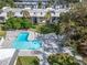 L-shaped pool with surrounding patio and lounge chairs at 107 Caldwell Dr # 291, Brandon, FL 33510