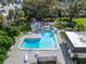 L-Shaped pool with patio and lounge chairs in a lush green community setting at 107 Caldwell Dr # 291, Brandon, FL 33510
