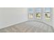 Bedroom with plush carpet and a bay window showcasing neighborhood views at 11208 Shoreline Trl, Parrish, FL 34219
