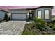 Exterior elevation featuring a well maintained lawn and paved driveway at 11208 Shoreline Trl, Parrish, FL 34219