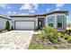 Charming one-story home with manicured lawn, paver driveway, and inviting facade at 11208 Shoreline Trl, Parrish, FL 34219