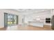 Spacious kitchen with white cabinets, stainless steel appliances, and sliding doors to the patio at 11208 Shoreline Trl, Parrish, FL 34219