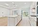 Bright, open kitchen featuring an island, stainless steel appliances, and ample counter space at 11208 Shoreline Trl, Parrish, FL 34219
