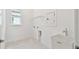Utility room with sink, window, and space for laundry appliances at 11208 Shoreline Trl, Parrish, FL 34219