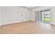 Open living room featuring wood floors and sliding glass doors to the outdoors at 11208 Shoreline Trl, Parrish, FL 34219