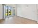 Bright living room with wood floors, sliding glass door, and neutral decor at 11208 Shoreline Trl, Parrish, FL 34219