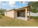 Home exterior showcasing a covered patio and grassy yard at 11438 Crestlake Village Dr, Riverview, FL 33569