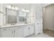 Bathroom featuring double vanity, large mirror, and tiled walk-in shower at 11477 Waterway Dr, Parrish, FL 34219
