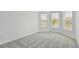 Bright bedroom with carpet, two windows, and neutral walls at 11477 Waterway Dr, Parrish, FL 34219
