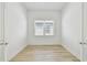 Sunlit bedroom with wood-look flooring and a window that provides natural light at 11477 Waterway Dr, Parrish, FL 34219