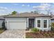 Charming single-Gathering home featuring a two-car garage, well-maintained landscaping and light-blue exterior paint at 11477 Waterway Dr, Parrish, FL 34219