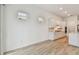 Open and airy living area featuring a modern kitchen with white cabinets, stainless appliances, and hardwood floors at 11477 Waterway Dr, Parrish, FL 34219