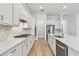 Elegant kitchen featuring stainless steel appliances, quartz countertops, white cabinets, and modern backsplash at 11477 Waterway Dr, Parrish, FL 34219