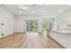 Bright and open living space with sliding glass doors and a modern kitchen, perfect for entertaining at 11477 Waterway Dr, Parrish, FL 34219