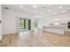 Open floor plan featuring a modern kitchen, spacious living area, and sliding glass doors to the outdoors at 11477 Waterway Dr, Parrish, FL 34219