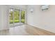 Bright living area with sliding glass doors leading to outdoor space and wood-look flooring at 11477 Waterway Dr, Parrish, FL 34219