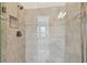 Modern shower with elegant tilework, glass door, and built-in niche, providing a luxurious bathing experience at 11477 Waterway Dr, Parrish, FL 34219