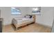 Light and airy bedroom with a full-size bed and hardwood floors at 12905 N Oregon Ave, Tampa, FL 33612