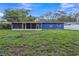 Large backyard with spacious grassy area and screened porch at 12905 N Oregon Ave, Tampa, FL 33612