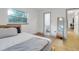 Main bedroom with a queen bed, en-suite bathroom access and hardwood floors at 12905 N Oregon Ave, Tampa, FL 33612