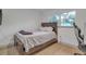 Bedroom with full-size bed, hardwood floors, and large windows at 12905 N Oregon Ave, Tampa, FL 33612
