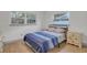 Bedroom with full-size bed, dresser, and hardwood floors at 12905 N Oregon Ave, Tampa, FL 33612
