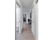 Hallway with light wood floors and doors at 12905 N Oregon Ave, Tampa, FL 33612