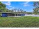 Large backyard with blue house and fence at 12905 N Oregon Ave, Tampa, FL 33612