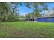 Spacious backyard with grassy area and home view at 12905 N Oregon Ave, Tampa, FL 33612