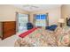Bedroom with a king-size bed, dresser, and access to a balcony at 14880 Shipwatch Trce # 1915, Largo, FL 33774