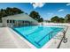 Inviting community pool with plenty of lounge chairs and a covered patio area at 14880 Shipwatch Trce # 1915, Largo, FL 33774