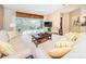 Bright living room featuring comfy sofas, a coffee table, and a large TV at 14880 Shipwatch Trce # 1915, Largo, FL 33774