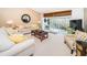 Living room with comfy sofas, a coffee table, and balcony access at 14880 Shipwatch Trce # 1915, Largo, FL 33774