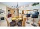 Bright dining area with glass table and four chairs, plus a breakfast bar at 14880 Shipwatch Trce # 1915, Largo, FL 33774