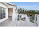 White wooden deck and railings, white siding, and blue awning on a sunny day at 14880 Shipwatch Trce # 1915, Largo, FL 33774