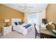 Cozy bedroom with a queen-size bed, desk, and ceiling fan at 14880 Shipwatch Trce # 1915, Largo, FL 33774