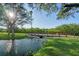 Scenic walkway over water with lush landscaping and sunny skies at 14880 Shipwatch Trce # 1915, Largo, FL 33774