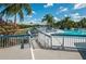 Community pool with adjacent marina featuring boat slips and relaxing lounge area at 14880 Shipwatch Trce # 1915, Largo, FL 33774