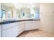 Bathroom with dual sinks, granite countertop, and a large shower at 14880 Shipwatch Trce # 1915, Largo, FL 33774