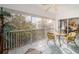 Screened balcony with seating area and view of trees at 14880 Shipwatch Trce # 1915, Largo, FL 33774