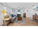 Living room with hardwood floors, gray couch, and a large TV at 16565 Mosaic Oar Dr, Wimauma, FL 33598