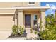 House exterior featuring a dark brown front door and a small porch at 16565 Mosaic Oar Dr, Wimauma, FL 33598