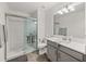 Bathroom with gray vanity, white subway tile, and shower at 17319 Holly Well Ave, Wimauma, FL 33598