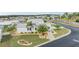 Aerial view of a single-story home with a landscaped yard in a residential community at 37652 New Horizons Blvd, Zephyrhills, FL 33541
