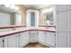 Bathroom with double vanity, corner cabinet, and red tile accents at 37652 New Horizons Blvd, Zephyrhills, FL 33541