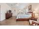 Main bedroom with king-size bed, dresser, and sitting area at 37652 New Horizons Blvd, Zephyrhills, FL 33541