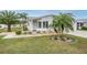 Front view of a house with palm trees and landscaping at 37652 New Horizons Blvd, Zephyrhills, FL 33541