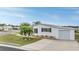Single-story home with white siding, attached garage, and landscaping at 37652 New Horizons Blvd, Zephyrhills, FL 33541