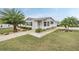 Single-story home with landscaped yard and driveway at 37652 New Horizons Blvd, Zephyrhills, FL 33541
